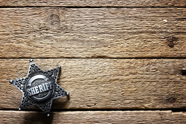 Sheriff star on wooden table — Stock Photo, Image