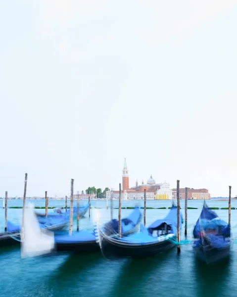 Row of gondolas parked on city pier — Stock Photo, Image