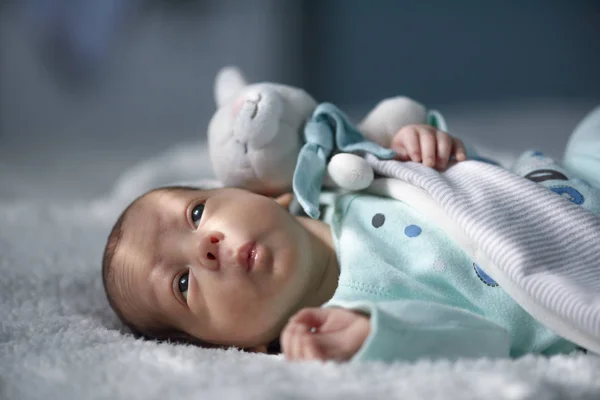 Newborn baby boy on white carpet closeup — Stock Photo, Image