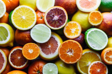 Mix of different citrus fruits closeup clipart