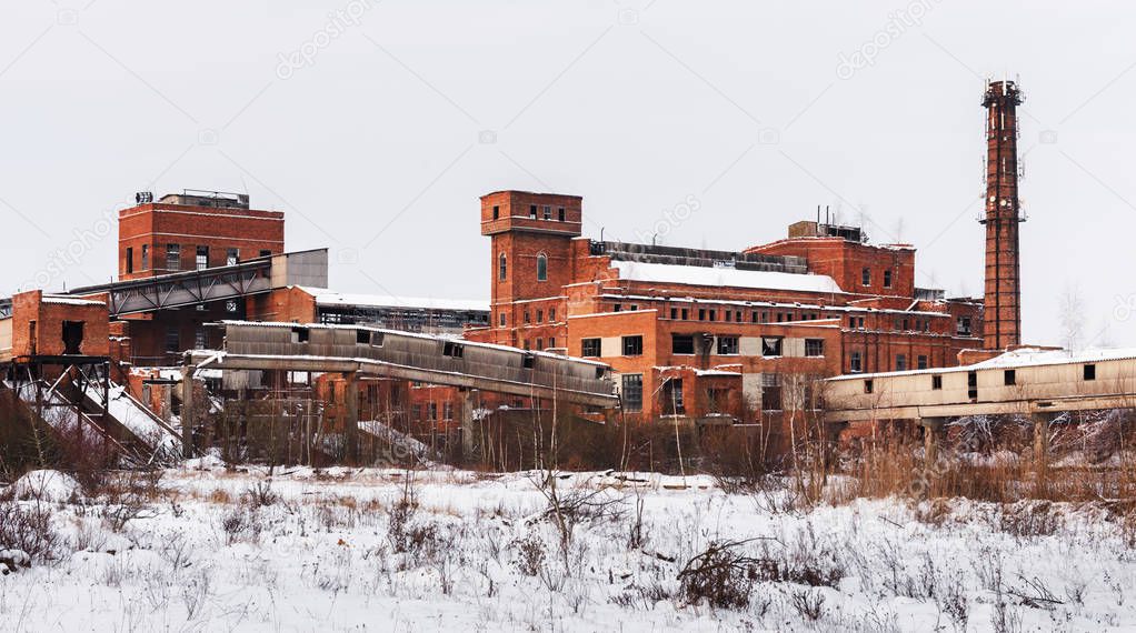 Old ruined factory construction in winter time.