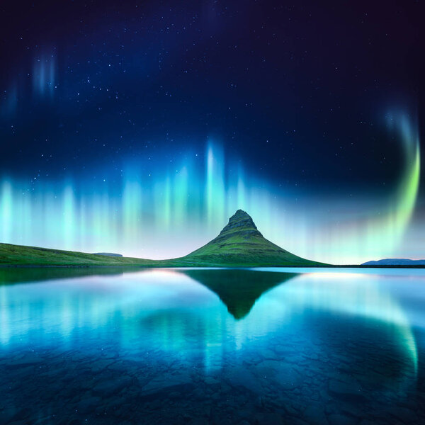 Green aurora light behind kirkjufell mountain