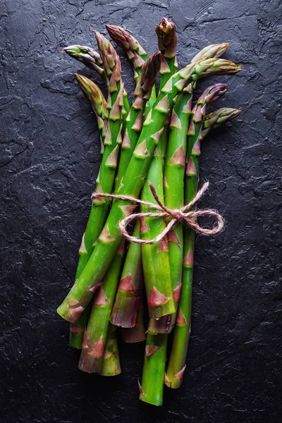 Green asparagus sprout on black board — Stock Photo, Image