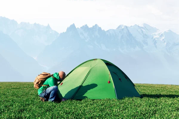 Green tent in spring mountains