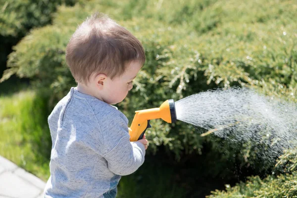 A boy watering soil — Stock Image A boy watering soil Royalty Free Stock Images