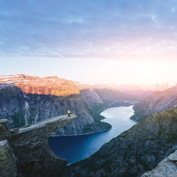 Tourist on Trolltunga rock in Norway mountains — Stock Photo, Image