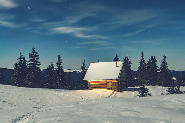 Fantastic landscape with snowy house