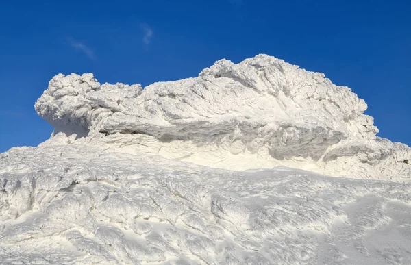 stock image Wonderful winter landscape on a sunny day. Unreal, fantastic, mystical, frozen texture with frost, ice and snow look like waves of the ocean. Incredible silhouette and form.