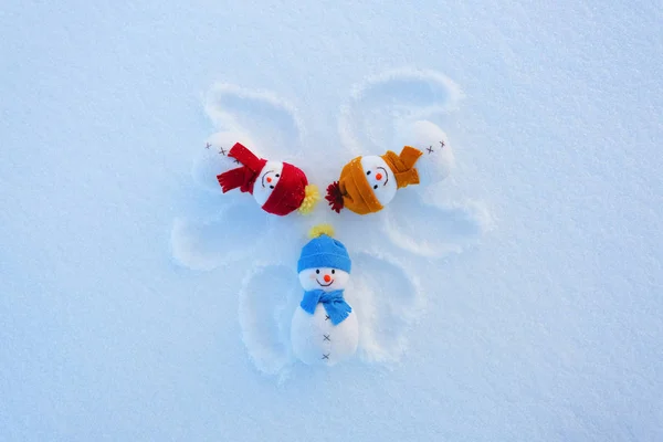 Three Funny Snowman Hats Scarfs Laying Snow Drawn Wings Fractured — Stock Photo, Image