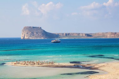 Beyaz insanlarla beach nerede alt-ebilmek var olmak seen, denizin dibinde kum. Güzel dağlar bir mavi ufuk üzerinde. Turist resort fantastik Bay, Balos. Güneşli bir yaz bir manzara.
