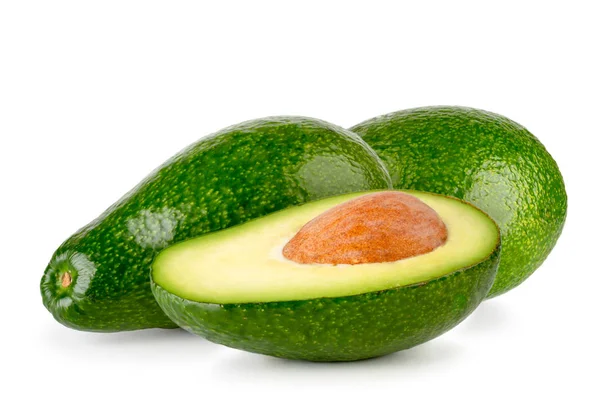 Two avocados and a half with a seed on a white background, — Stock Photo, Image
