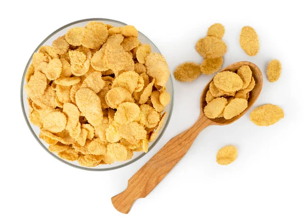 Corn flakes in bowl and wooden spoon on a white. The view from the top. — Stock Photo, Image