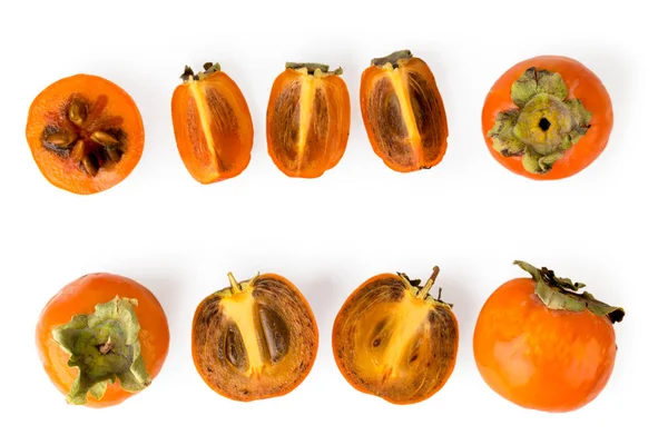 Persimmon set of different pieces on a white. The view from the top. — Stock Photo, Image