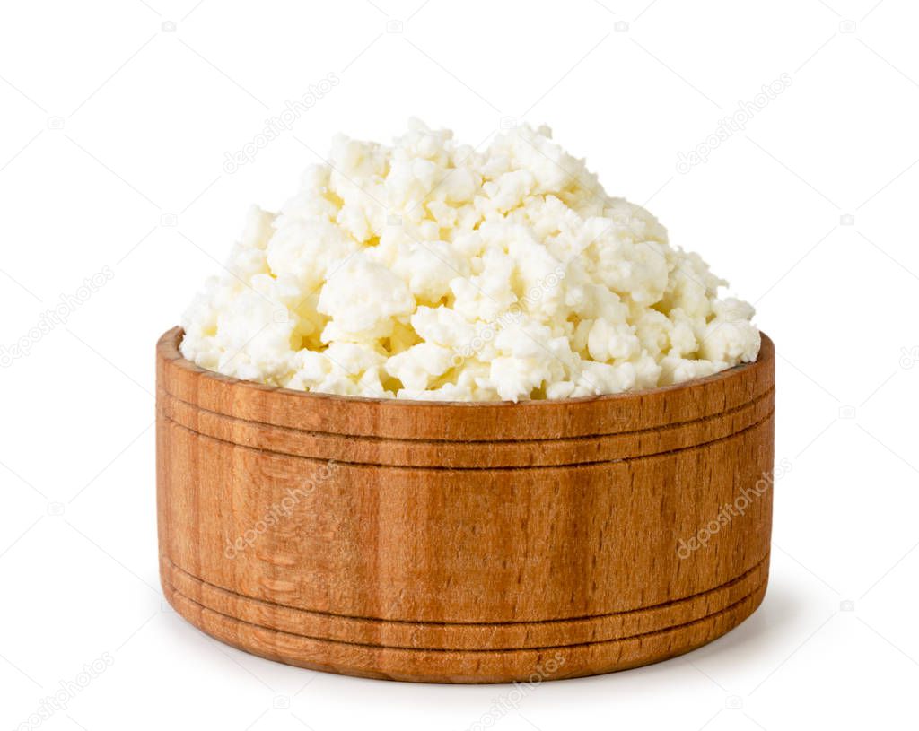 Curd in a wooden plate close-up on a white. Isolated