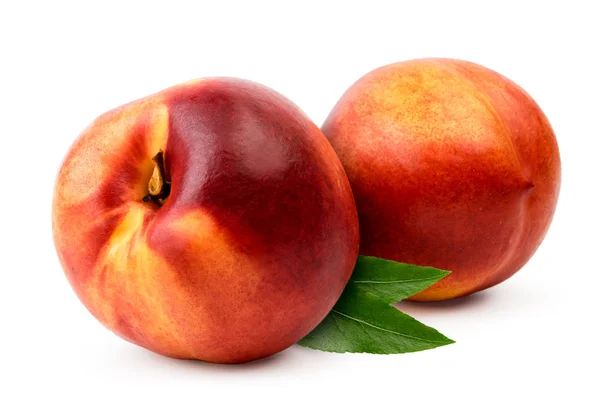Two nectarines with leaves close-up on a white background. — Stock Photo, Image