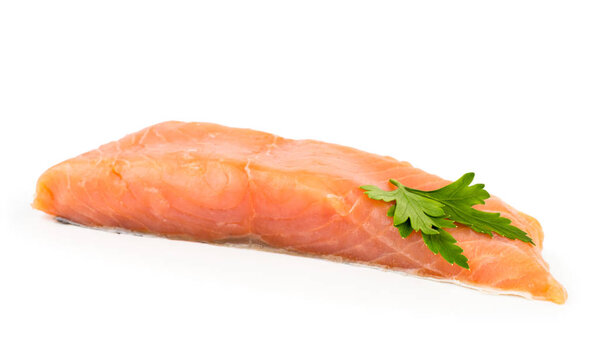 A piece of fresh salmon fish decorated with parsley leaf close-up on a white. Isolated.