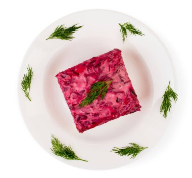 Salata ringa kürk beyaz tabakta altında yaprakları rezene ile süslüdür.