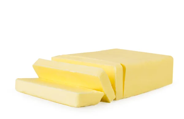 Um pedaço de manteiga cortada em pequenas porções . — Fotografia de Stock