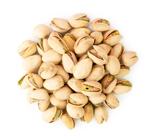 Heap of pistachios on a white. The view from the top. — Stock Photo, Image
