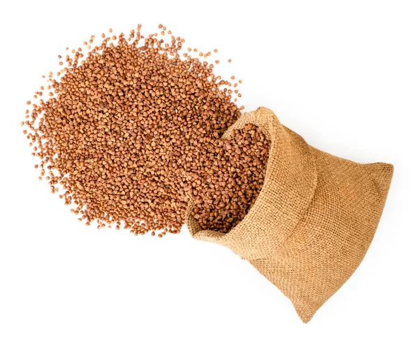 Buckwheat fell out of the bag on a white. The view from the top. — Stock Photo, Image