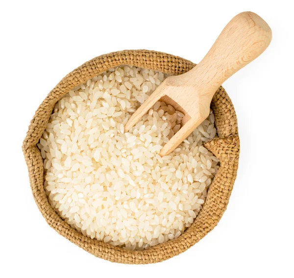 Rice in a bag and a wooden spoon on a white. Isolated. — Stock Photo, Image