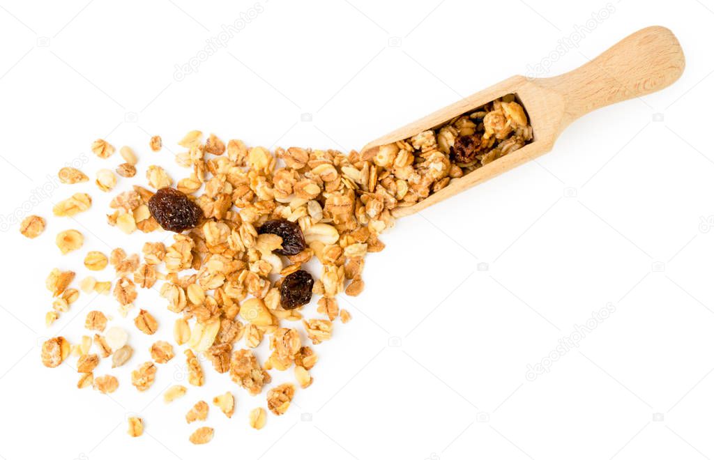 Muesli spilled from a wooden scoop on a white. The form of the top.