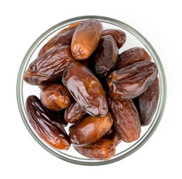 Dates in a glass plate on a white. The form of the top. — Stock Photo, Image