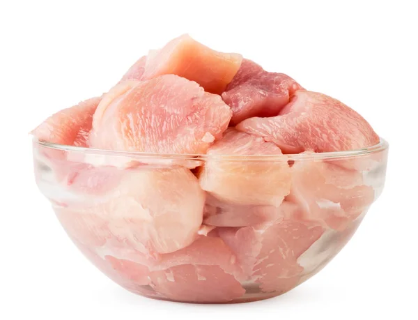 Chicken breast cut into pieces in a glass plate close-up on a white. Isolated. — Stock Photo, Image