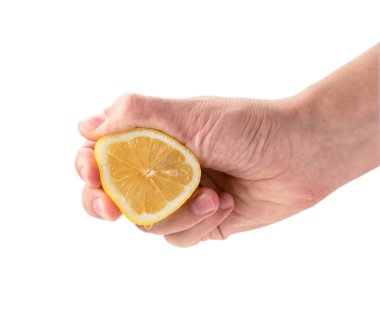 Hand squeezes lemon juice close - up on a white. Isolated. clipart
