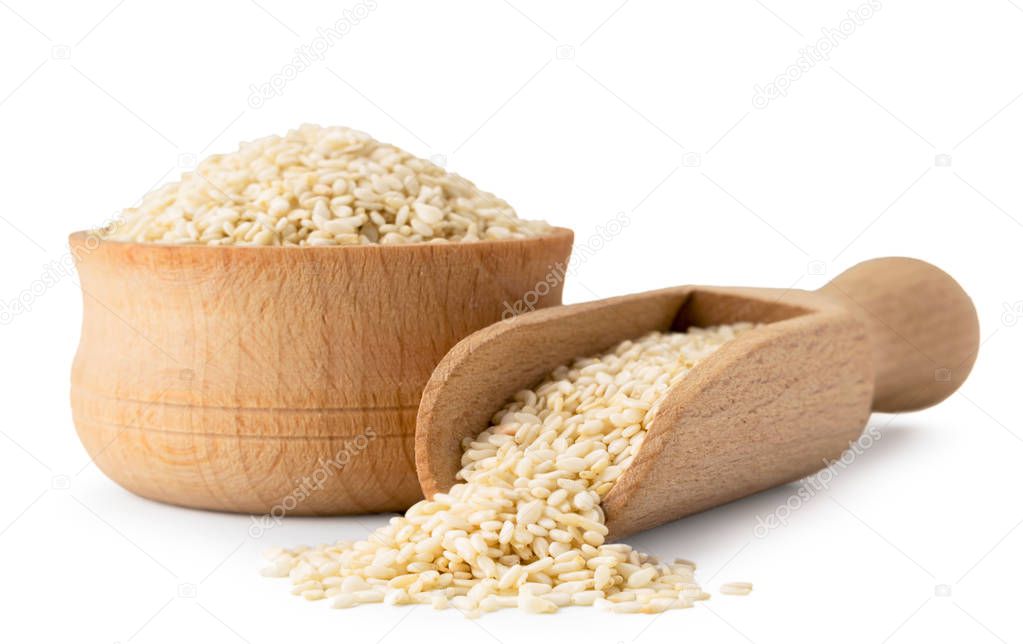 Sesame seeds in wooden plate and spoon on a white, isolated.