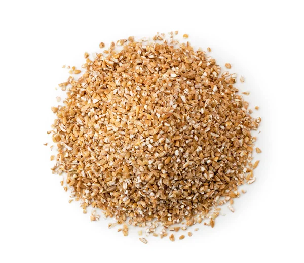 Heap of dry wheat groats on a white background. The form of the top. — Stock Photo, Image