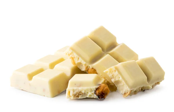 Broken white chocolate bar with nuts on a white. Isolated. — Stock Photo, Image