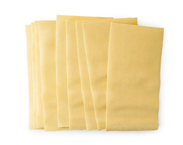 Fogli crudi di pasta lasagna su un bianco. La forma della parte superiore . — Foto Stock