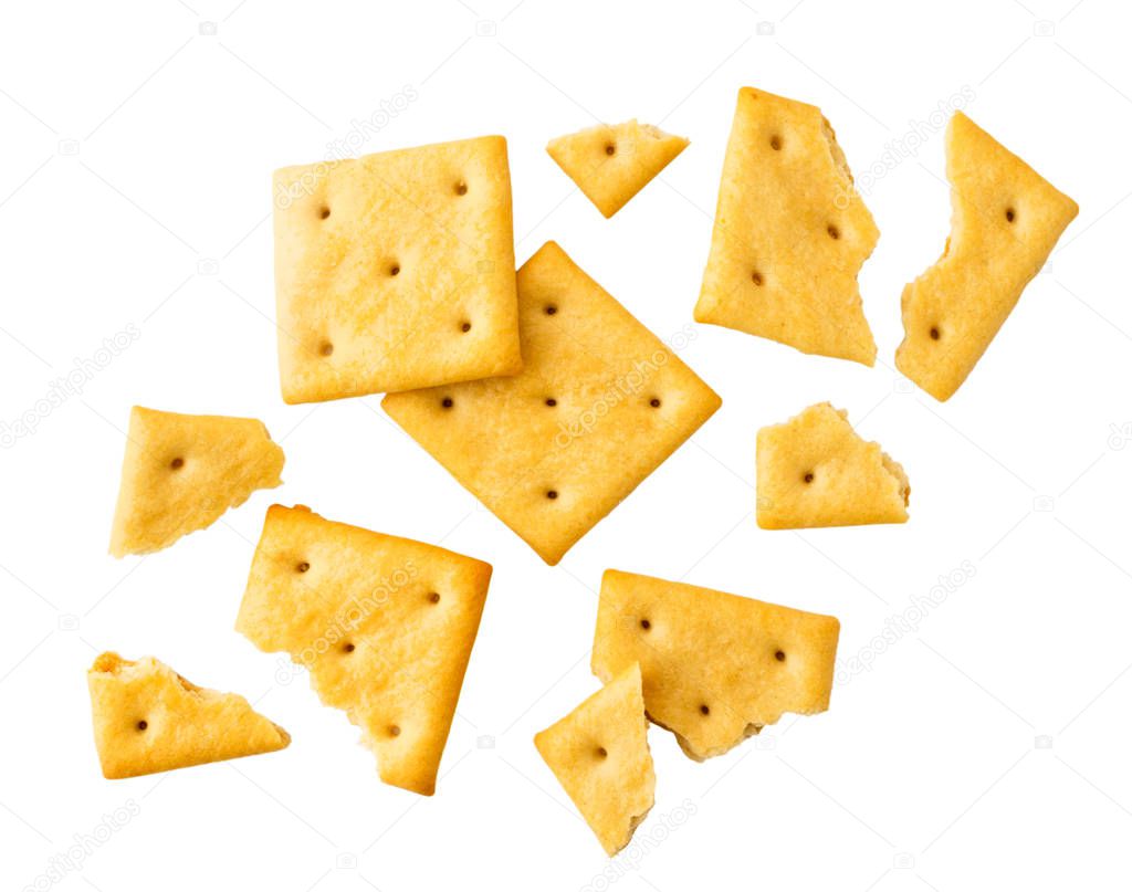 Cookies crackers and pieces are flying on a white. Isolated.