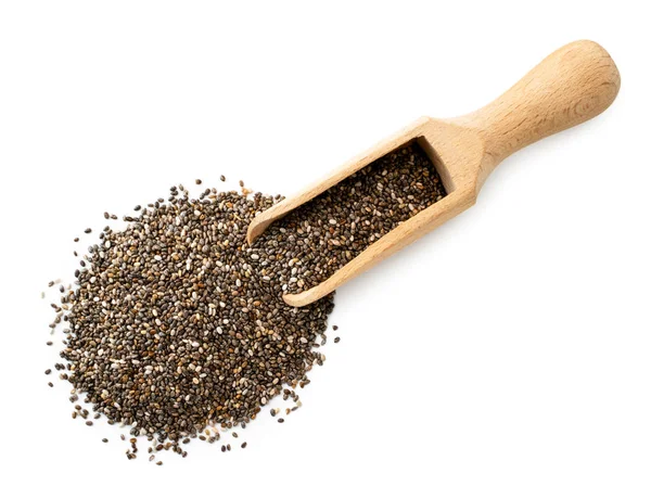 Chia tohumları tahta bir kaşıktan beyaza döküldü. Üst görünümü.