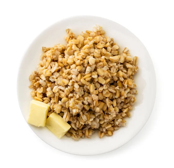 Beyaz tabakta tereyağlı yulaf ezmesi. Zirvenin manzarası.