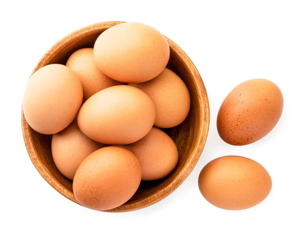 Kuřecí vejce v dřevěném talíři na bílém. Pohled na vrchol. — Stock fotografie