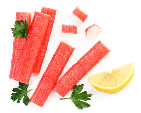 Crab sticks, parsley and lemon slice on a white background, isolated. Top view — Stock Photo, Image
