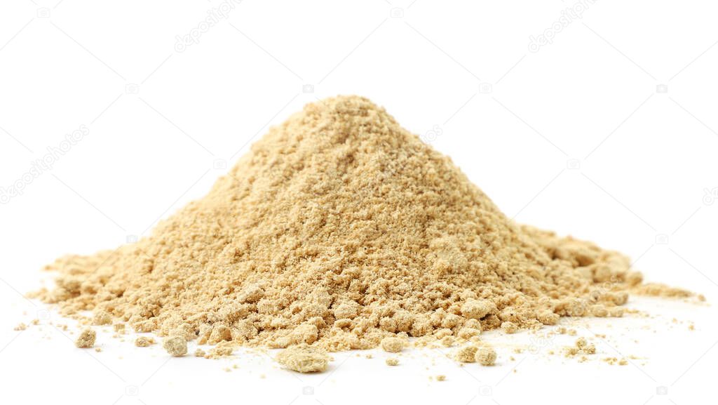 A pile of ground ginger close-up on a white background. Isolated