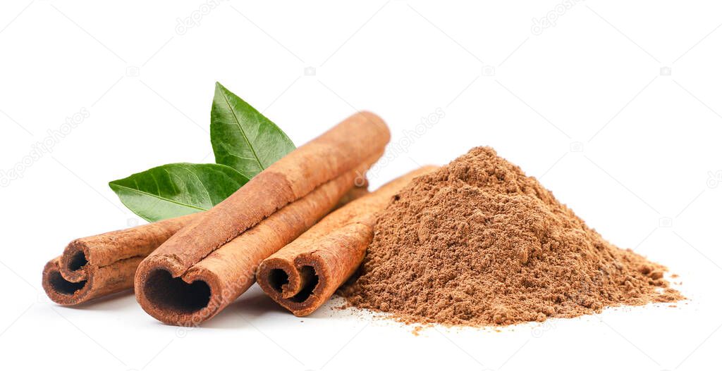 Cinnamon sticks and ground with fresh leaves on a white background. Isolated