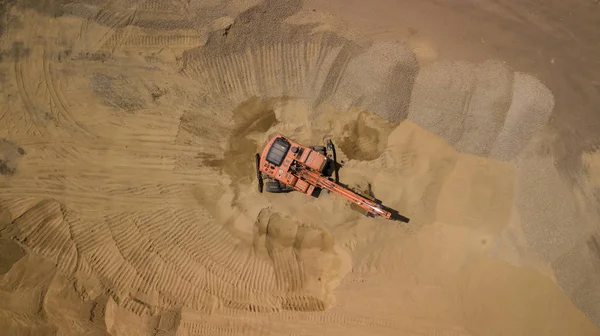 Aerial photo of excavator. On the construction site top view. Shooting from the drone/