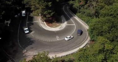 4 k hava Stok görüntüleri dolambaçlı dağ pass yol Sochi, Rusya'nın Ormanı boyunca sürüş araba. İnsanlar seyahat, güzel kırsal manzara virajlı yolda yolculuk.