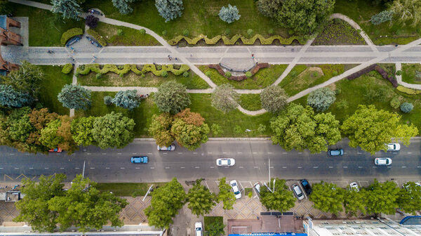 Aerial view from above of the vehicular intersection, traffic at peak hour with cars on the road.