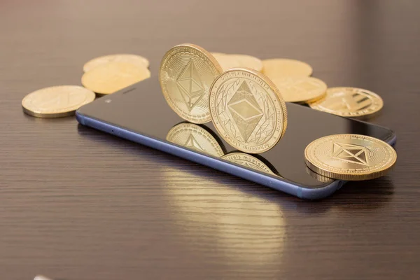 Golden Etherium coin close up on smartphone - business concept of crypto currency. — Stock Photo, Image