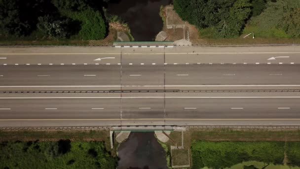 Top down close up of highway, white arrow signs indicating direction — Stock Video