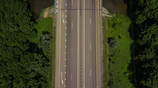 Top down close up of highway, white arrow signs indicating direction — Stock Photo, Image