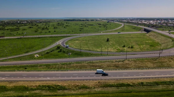 Aerial view of modern highway road intersection on rural landscape — Stock Photo, Image