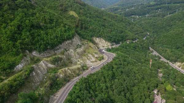 Drones Eye View-kronkelende weg van de hoge bergpas in Sotsji, Rusland. Geweldige Road Trip door de dichte bossen. — Stockfoto
