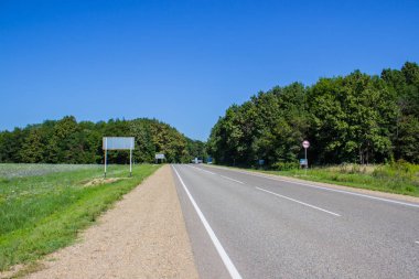 ağaçlar ve mavi gökyüzü ile kırsal alanda yol