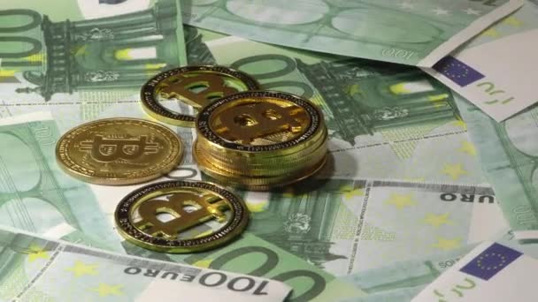 Gold Bit Coin BTC coins rotating on bills of 100 euro banknotes. Worldwide virtual internet cryptocurrency. — Stock Video